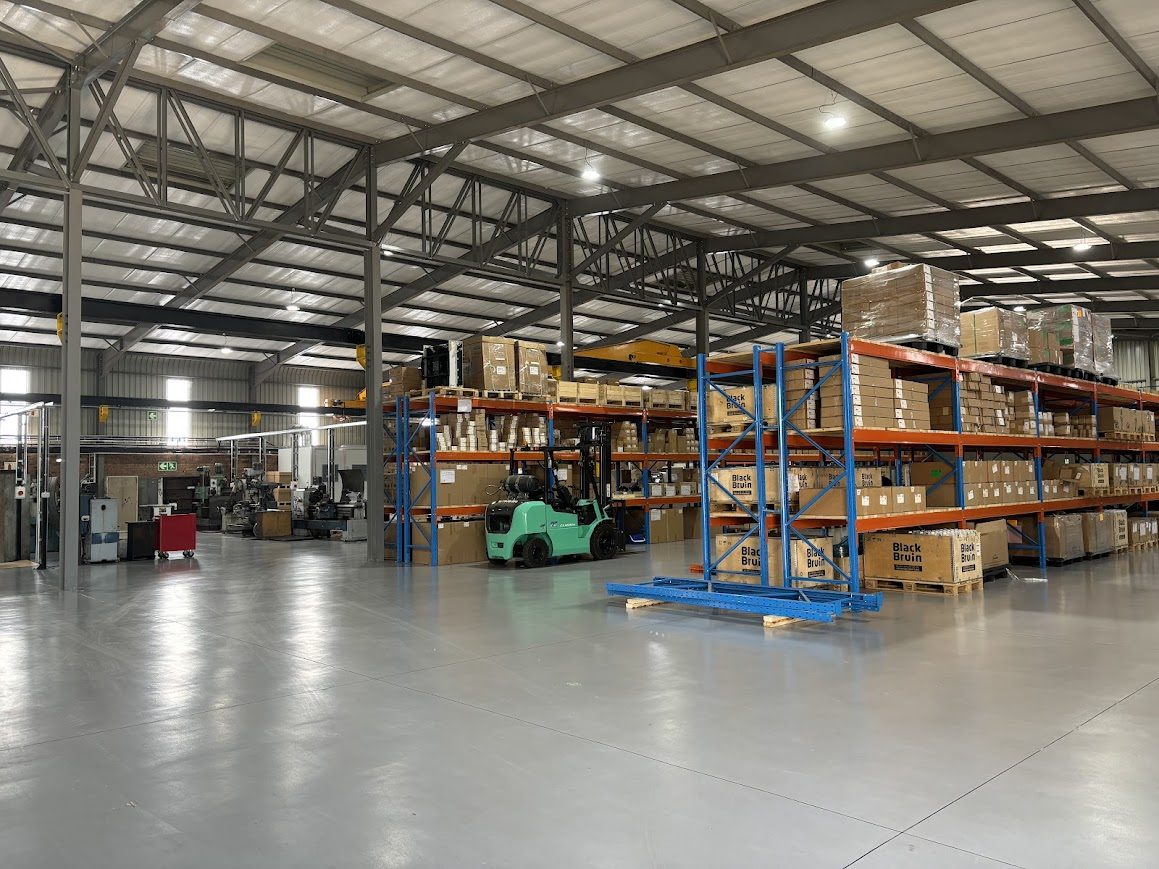 Axiom Hydraulics stores with racked Black Bruin stock and a forklift